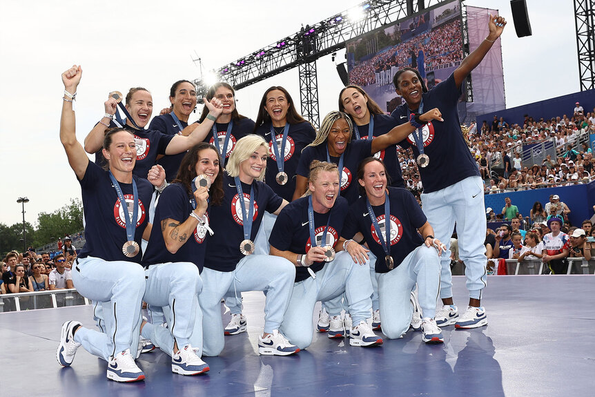 Team United States Women's Rugby Seven's athletes pose for a photo with their bronze medals