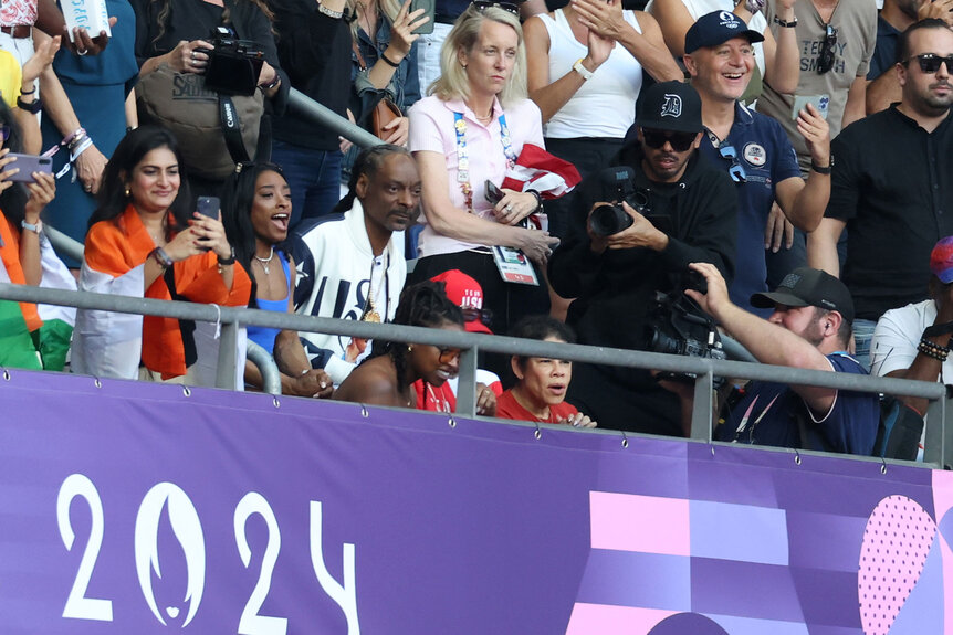 Gold medal gymnast Simone Biles of Team United States and Snoop Dogg look on at Stade de France at theParis 2024 Olympics