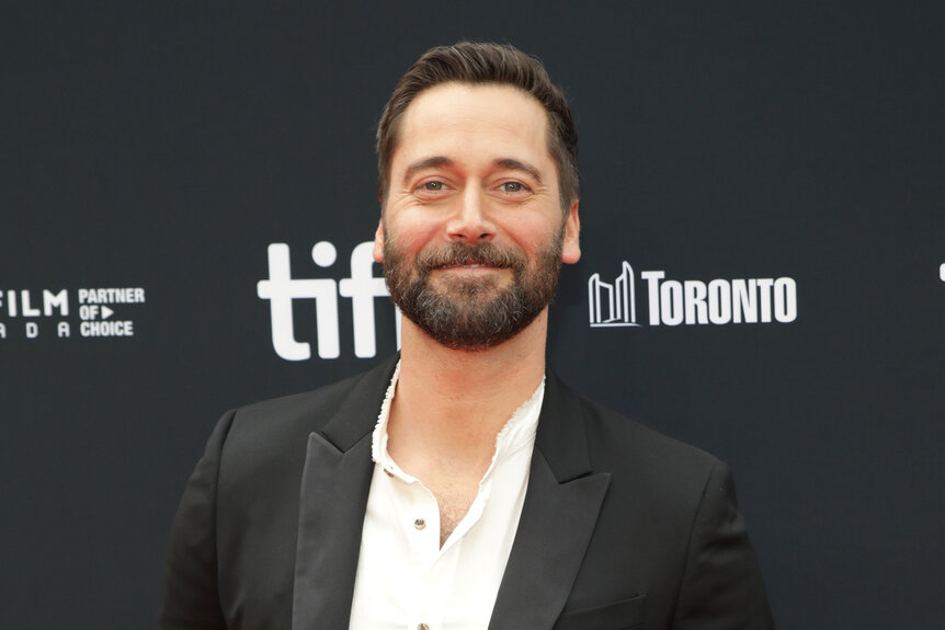 Ryan Eggold wears a black suit to a movie premiere