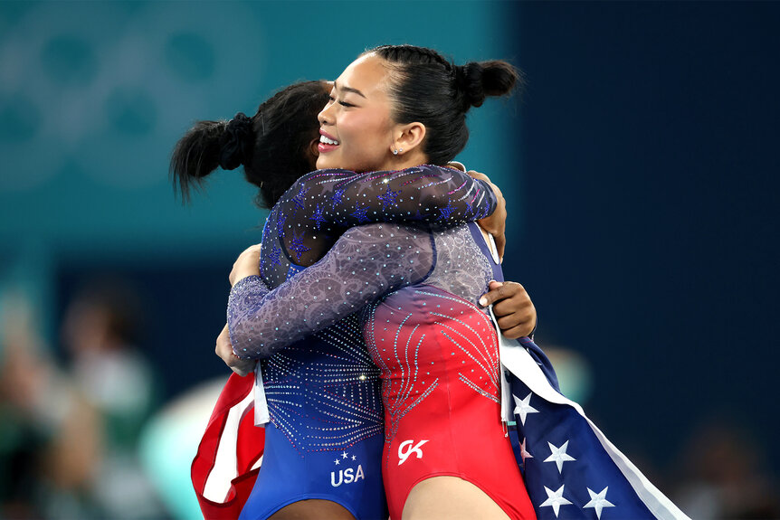 Simone Biles and Suni Lee hug after winning gold and bronze medals at the 2024 olympics