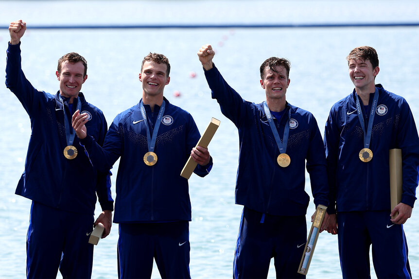 Team Usa Rowing on the podium celebrating their gold medals at the 2024 Olympics