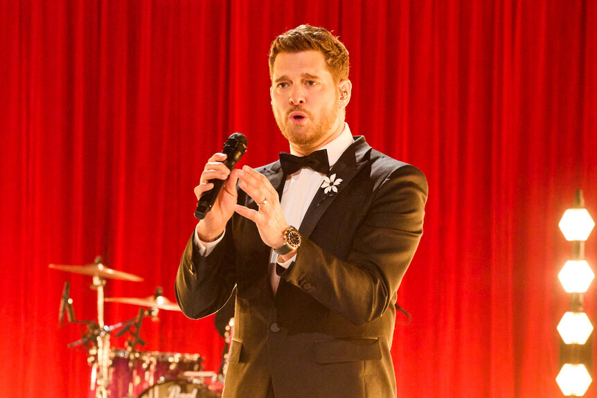 Michael Bublé sings on stage in a tuxedo on The Voice season 26