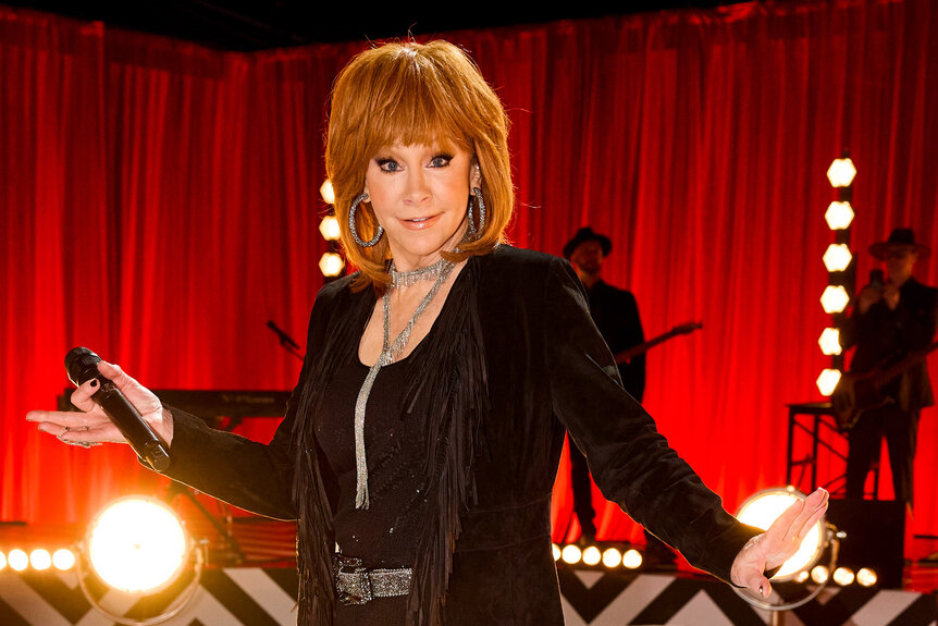 Reba McEntire sings and dances in a black jacket on The Voice season 26