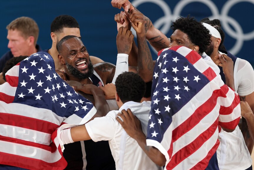 The U.S. Men's basketball team celebrates their gold medal at the 2024 Olympics