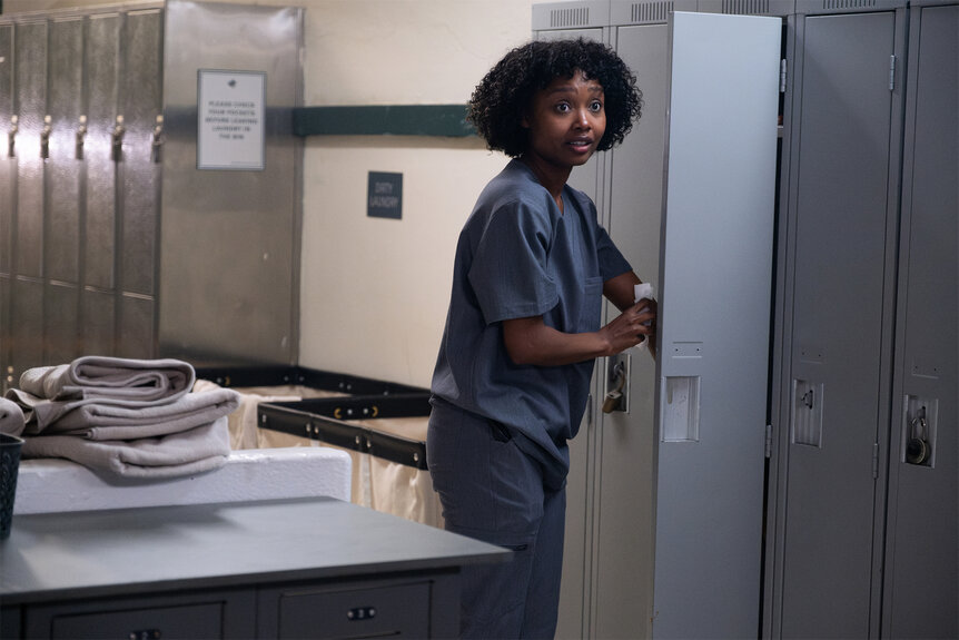 Dr Ericka Kinney grabs something in her locker on Brilliant minds episode 101