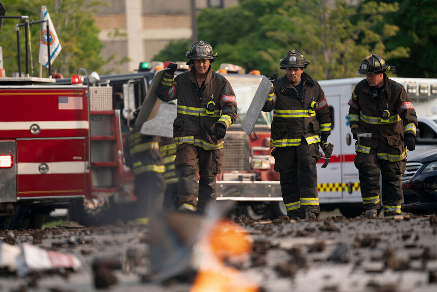 Kelly Severide and Joe Cruz walk amongst rubble