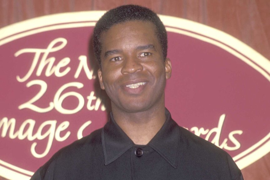 David Alan Grier smiles in a black shirt at the NAACP Image Awards