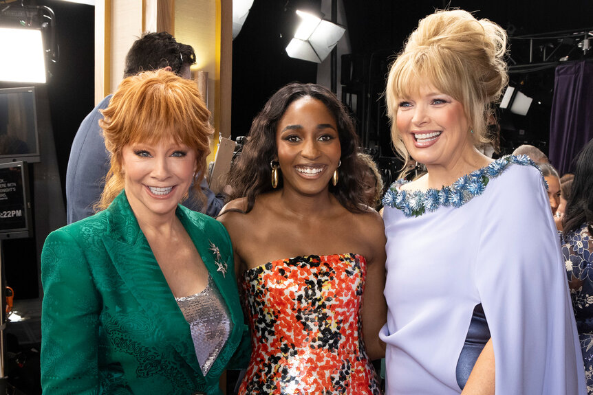 Reba Mcentire Ayo Edebiri and Melissa Peterman pose together on the red carpet at the Emmy Awards