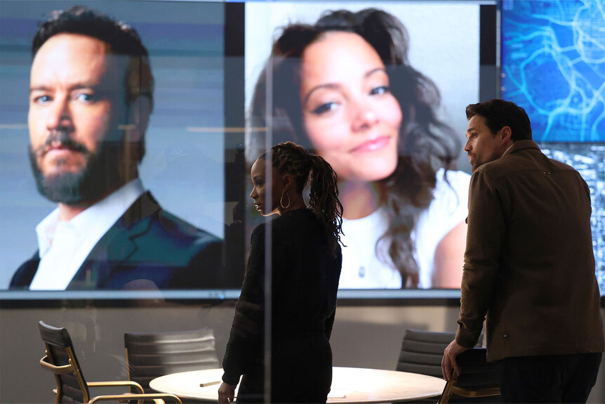 Gabi (Shanola Hampton), and Detective Mark Trent (Brett Dalton) stand in a conference room