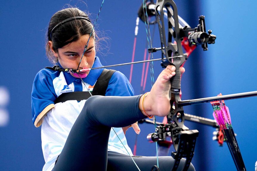 Sheetal Devi shoots a bow and arrow with her feet at the 2024 Paralympic Games.