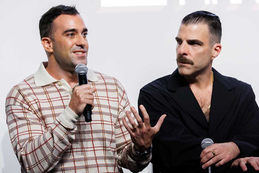 Michael Grassi and Zachary Quinto during a panel on stage