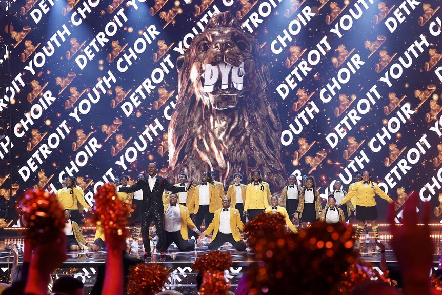 Terry Crews and the Detroit Youth Choir stand onstage on America's Got Talent Episode 1920.