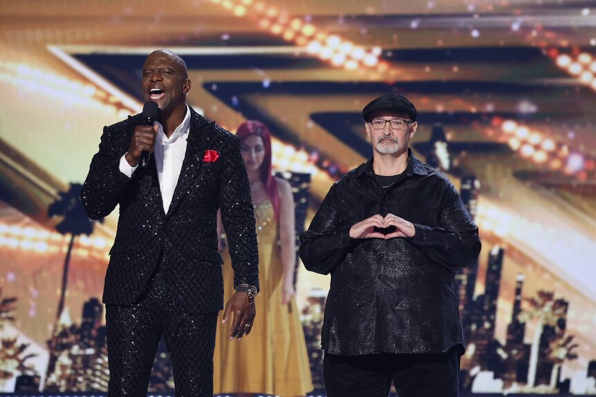 Terry Crews and Richard Goodall smile onstage on America's Got Talent Episode 1920.5134 04987