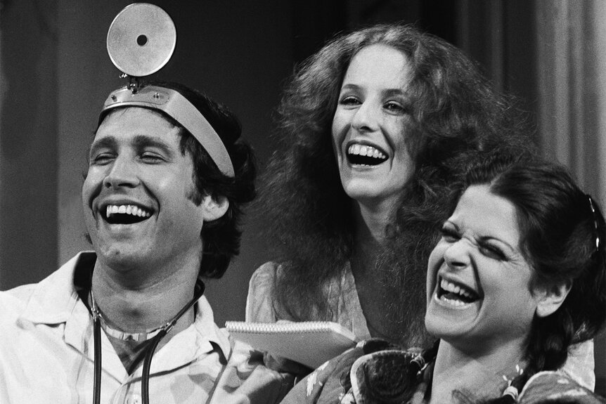 Chevy Chase Laraine Newman and Gilda Radner during a sketch on SNL in 1976