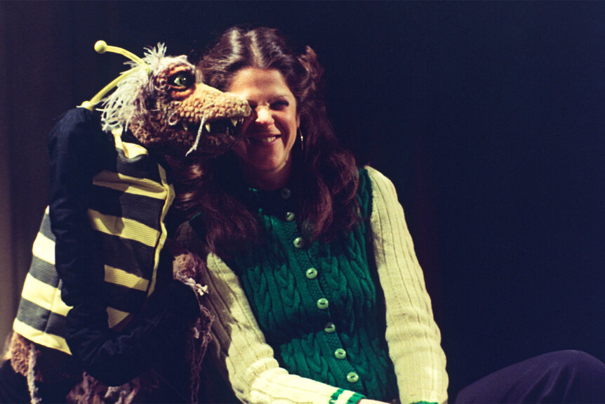 Glida Radner sits next to a puppet during a sketch on Saturday Night Live