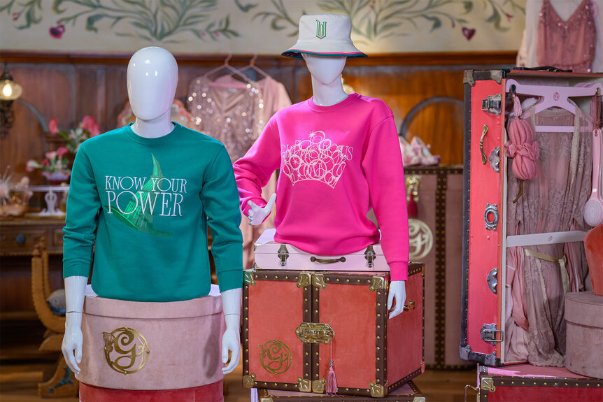 Mannequins wear sweatshirts from The Wicked Experience at universal parks