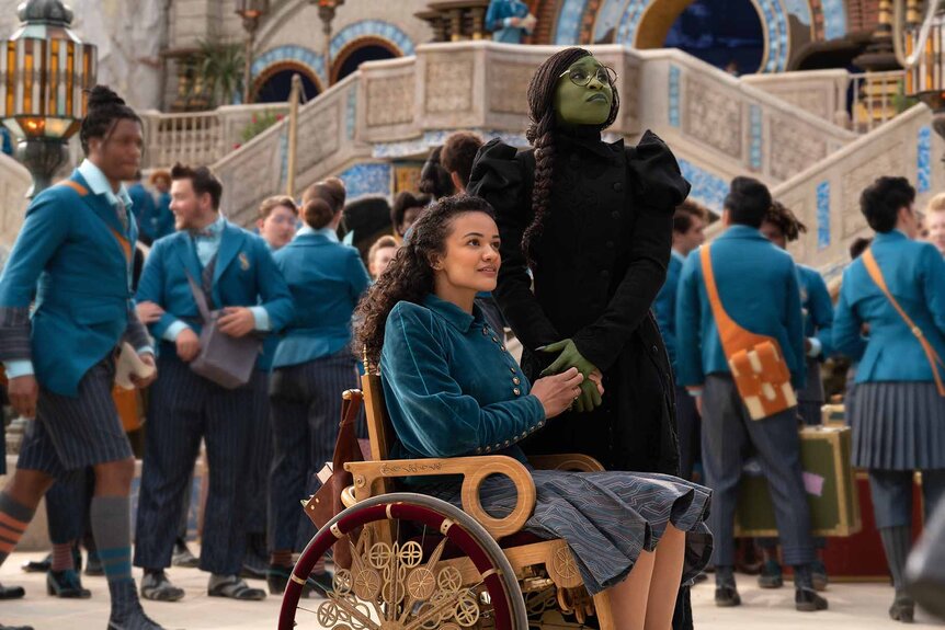 Nessarose (Marissa Bode) and Elphaba (Cynthia Erivo) look around a school in Wicked (2024).