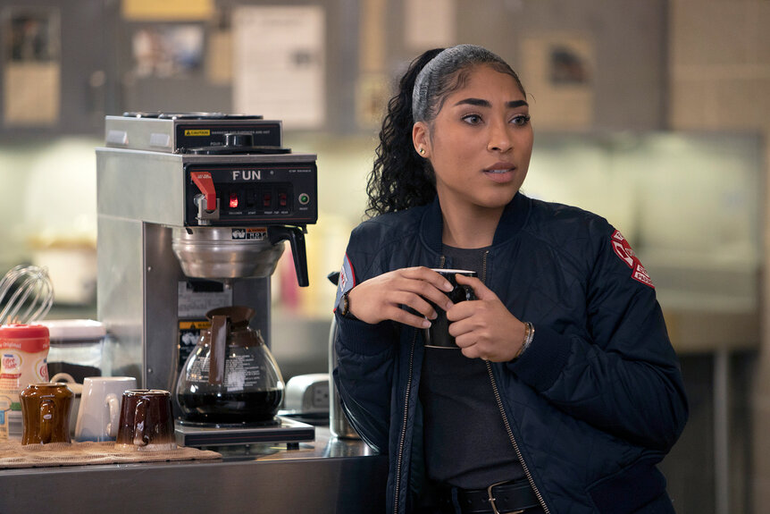 Gianna Mackey (Adriyan Rae) holds a coffee mug on Chicago Fire Season 9 Episode 6.