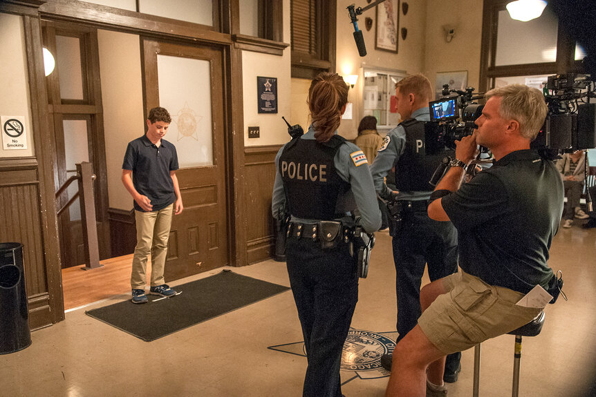 A camera man films as Chicago PD films in the police department on Chicago P.D Season 2 Episode 6