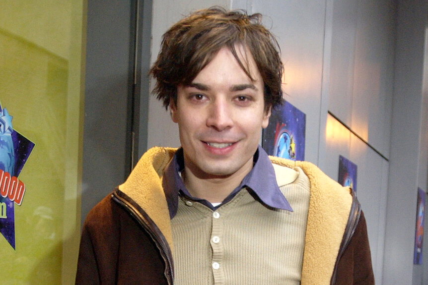 Jimmy Fallon smiles in a brown jacket at a super bowl party in 2002