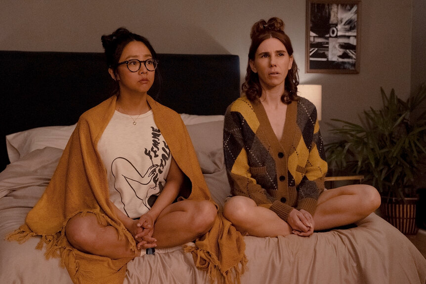 Aj and Ruby sit on a bed on Laid Season 1 Episode 5