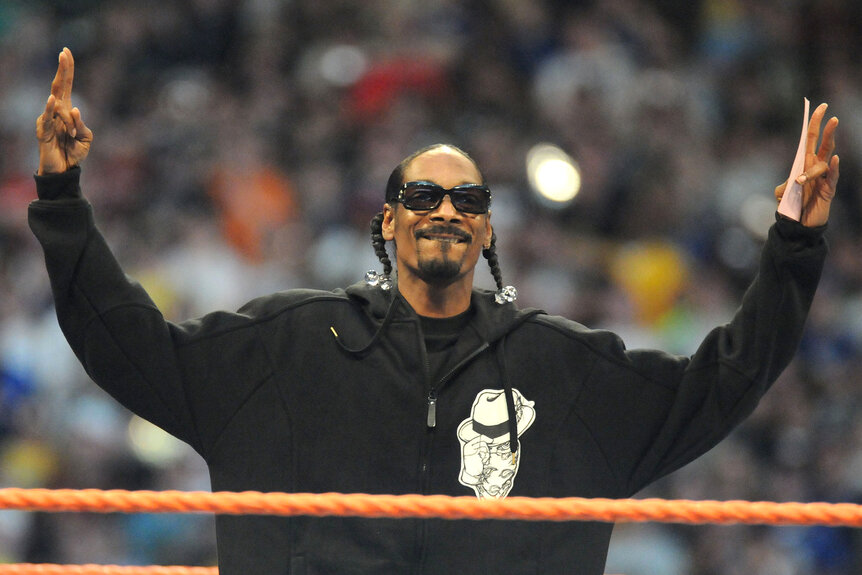 Snoop Dogg wears a black hoodie in the wrestling ring at Wrestlemania XXIV