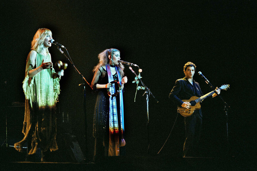 Fleetwood Mac, L-R: Christine McVie, Stevie Nicks, and Lindsey Buckingham performing live onstage at the Wembley Arena