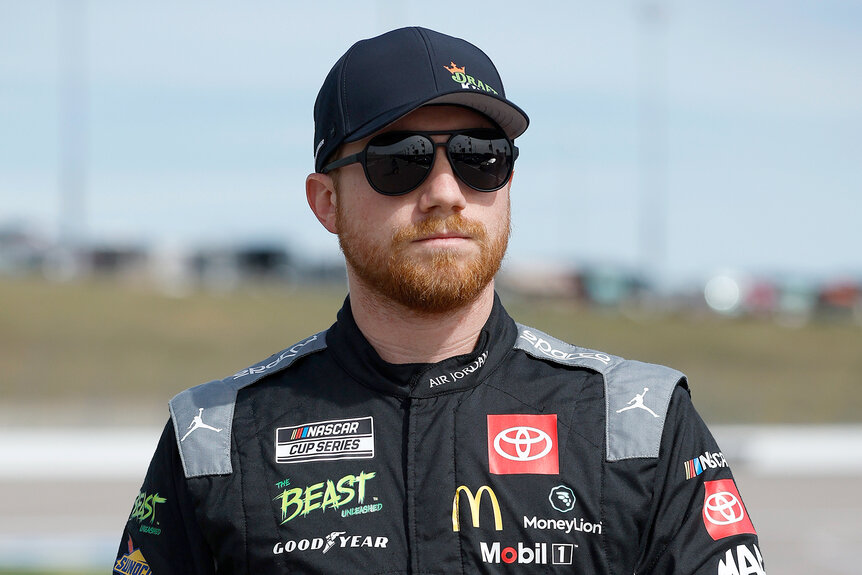 NASCAR driver Tyler Reddick walks on the grid during practice