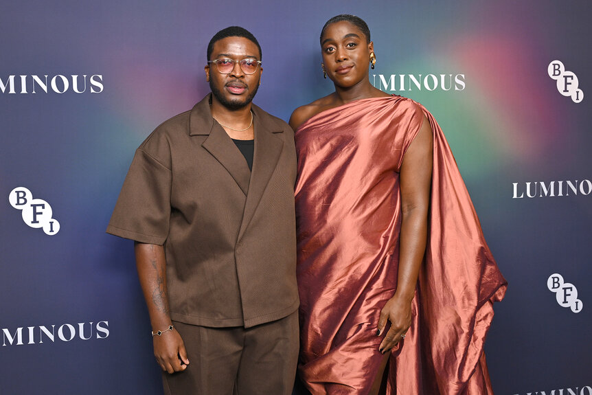 Zackary Momoh and Lashana Lynch pose together at an event