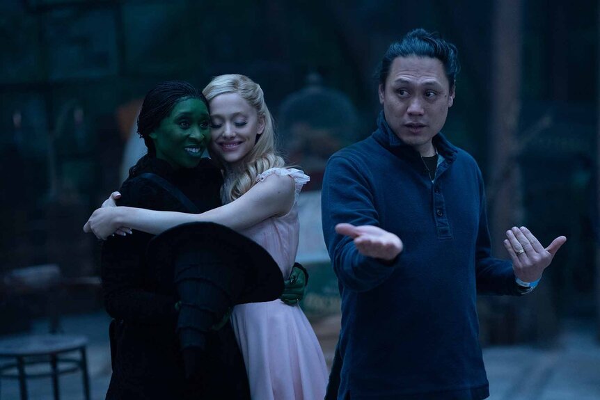 Jon M. Chu directs Elphaba (Cynthia Erivo) and Glinda (Ariana Grande) on the set of Wicked (2024).