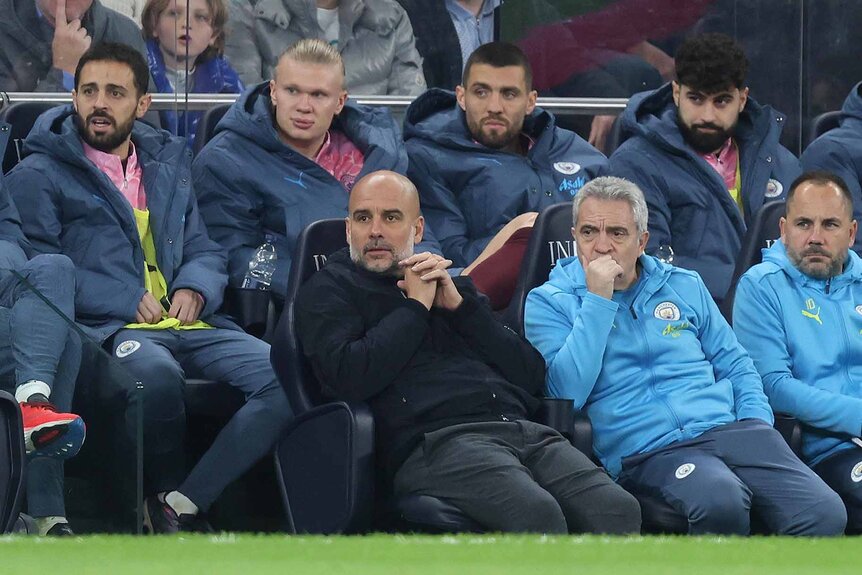 Members of Manchester City watch a game.