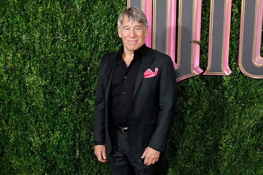 Stephen Schwartz smiles in a suit.