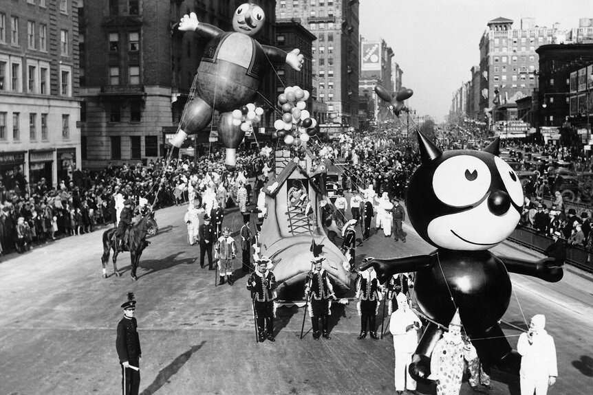 A Felix the Cat balloon, followed by Terrible Turk and Willie Red Bird balloons are led down Broadway during the annual Macy's Thanksgiving Day Parade in 1932