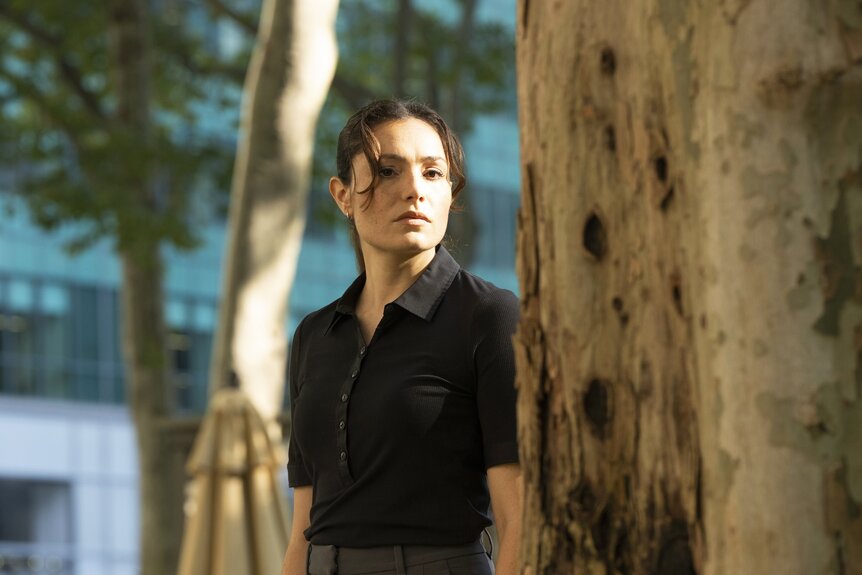 Det. Kate Silva (Juliana Aidén Martinez) looks at a tree trunk in Law & Order: Special Victims Unit Episode 26002.