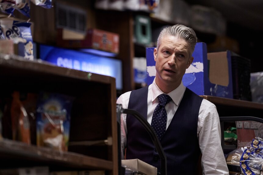 A.D.A Dominick "Sonny" Carisi Jr. (Peter Scanavino) stands in a deli in Law & Order: Special Victims Unit Episode 26008.