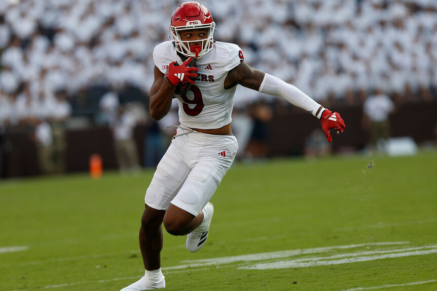 A player on the Rutgers Scarlet Knights takes the ball and runs down the field