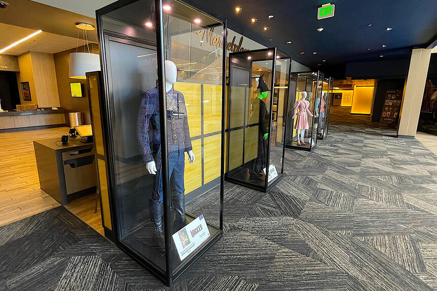 Glass cases of costumes from Wicked at Universal Studios Hollywood