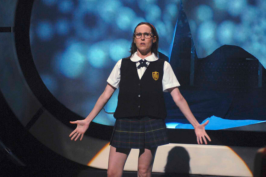 Mary Katherine Gallagher (Molly Shannon) stands onstage in a schoolgirl uniform.