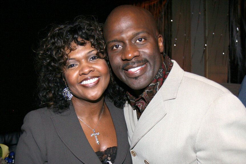 Cece Winans and Bebe Winans embrace each other and smile together