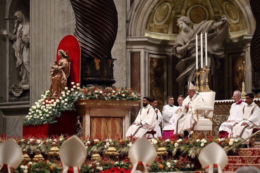 Pope Francis sits at the head of St. Peter's Basilica.