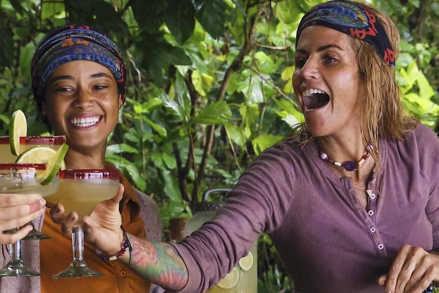 Lauren Harpe and Carolyn Wiger smile and cheers margaritas on Survivor Season 44.