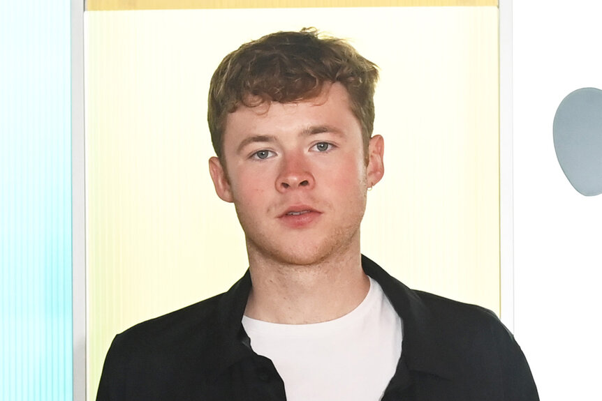 Harry Redding stands in a black jacket and white shirt.