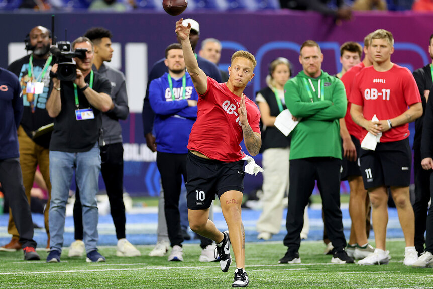 A quarter back from south carolina throws a football during the NFL Combine