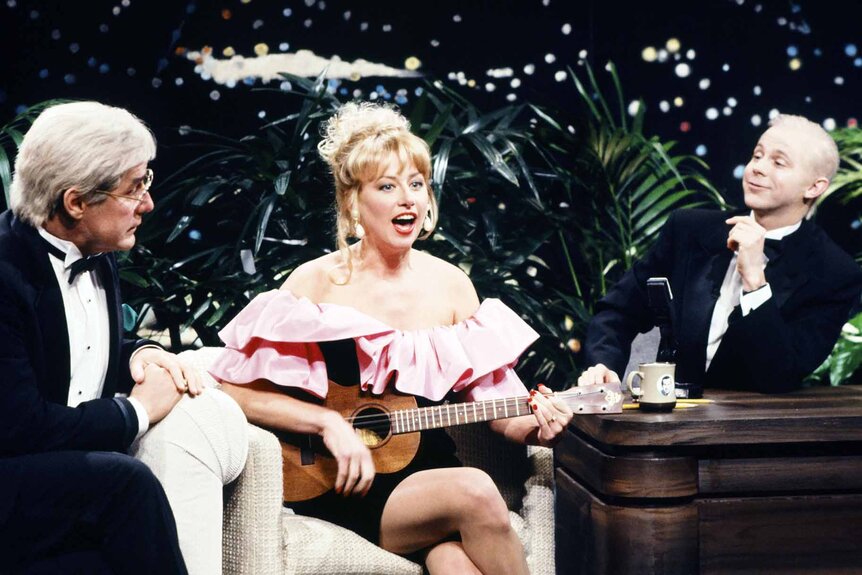 Ed McMahon (Phil Hartman), Victoria Jackson, and Johnny Carson (Dana Carvey) act as they're on a talk show during a SNL Sketch.