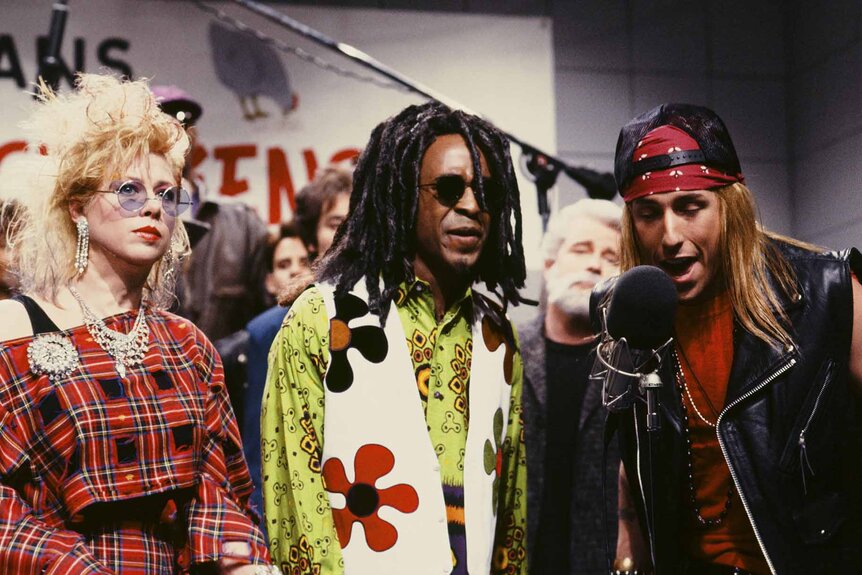 Cyndi Lauper (Victoria Jackson), Lenny Kravitz (Tim Meadows), and Axl Rose (Adam Sandler) sing together during an SNL Sketch.