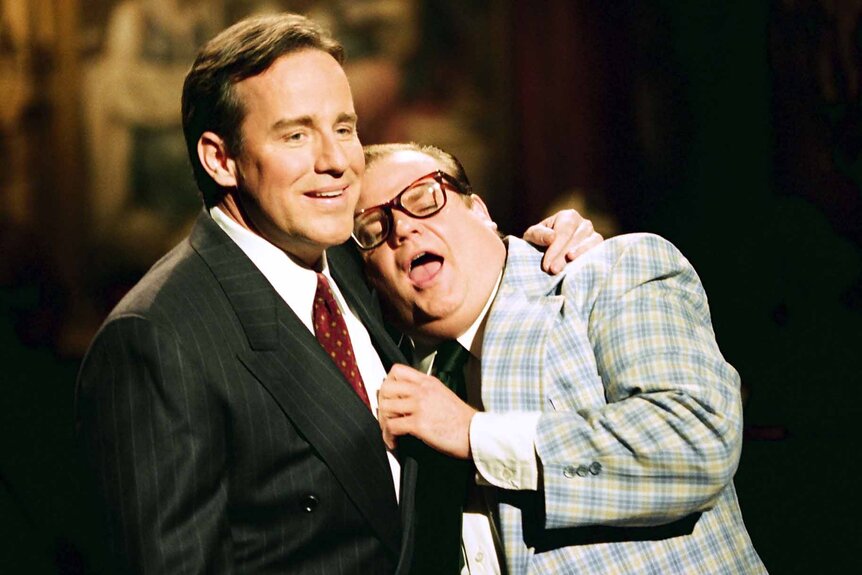 Phil Hartman holds a crying Chris Farley on SNL.