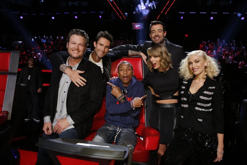 Taylor Swift and Pharrell Williams smile and pose with the coaches on The Voice Episode 715B.