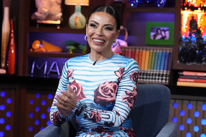 Dolores Catania smiles in a striped floral dress.