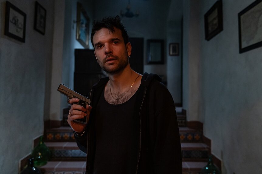 Alvaro (Jon Arias) holds a gun in The Day of the Jackal Episode 110.