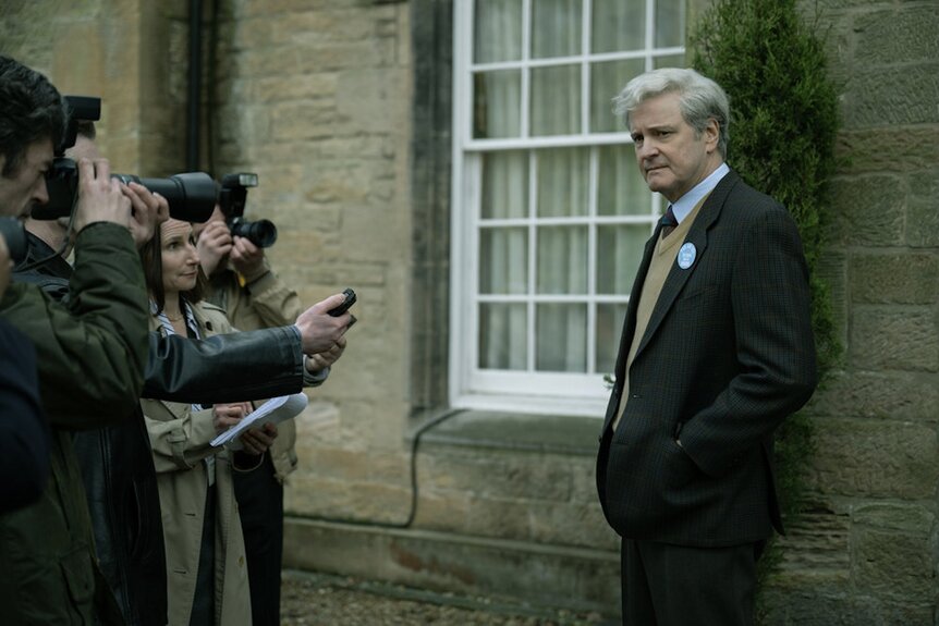 Jim Swire (Colin Firth) stands in front of a group of press in Lockerbie: A Search for Truth Episode 102.